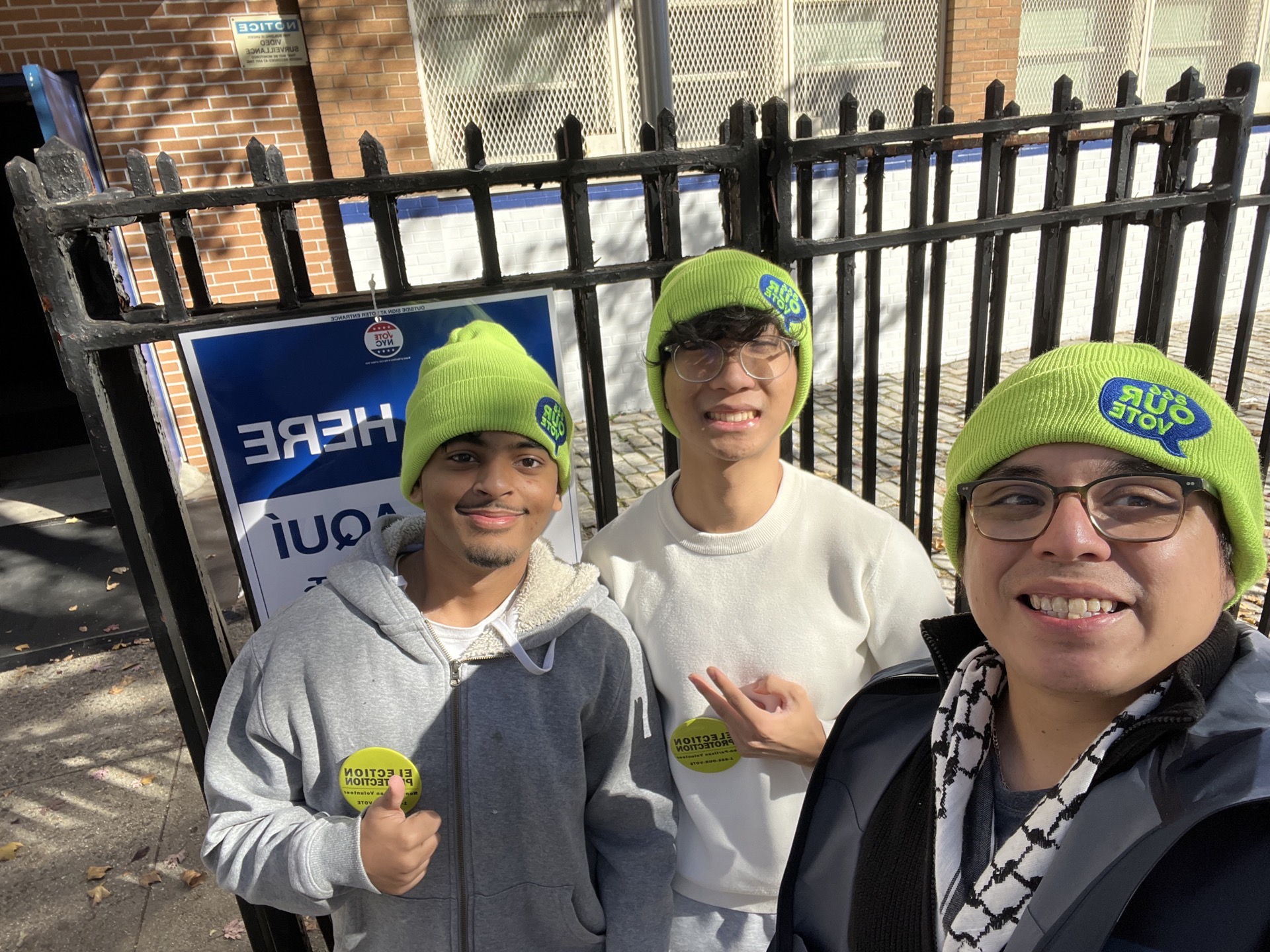 Three young election protection volunteers outside a polling place
