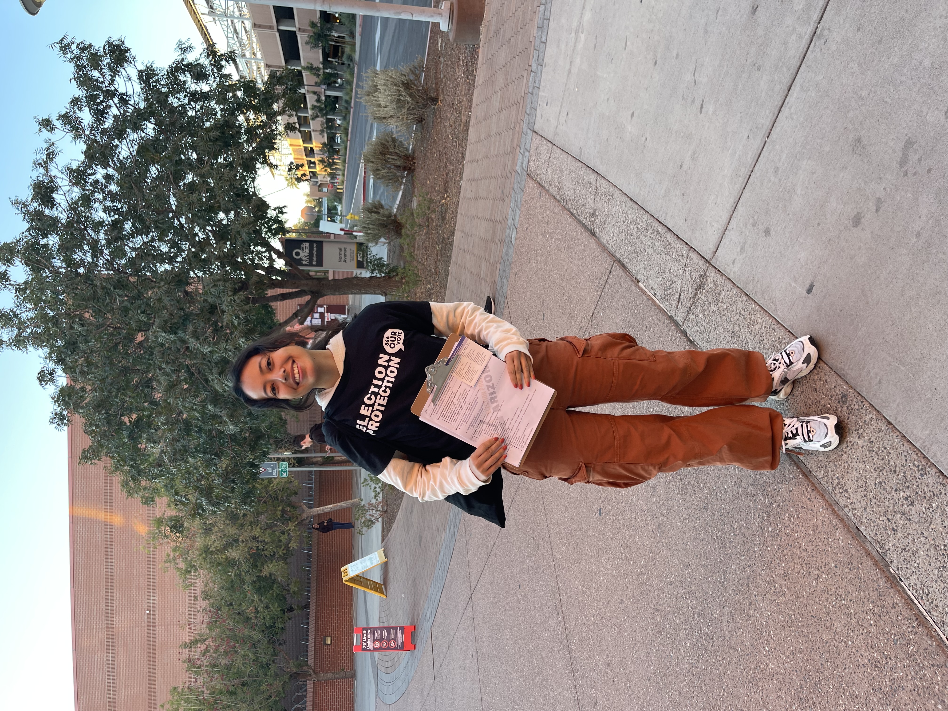 Young election protection volunteer holding a clipboard